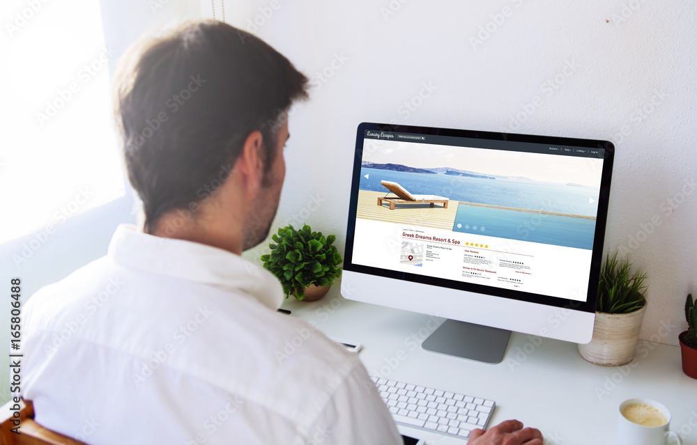 Poster man browsing resort and spa website on computer