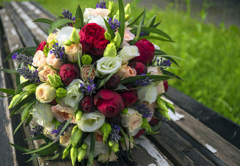 A wedding bouquet lies on wooden blocks.