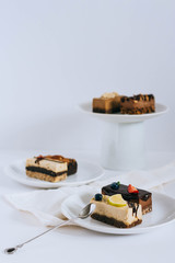 Assortment of useful raw desserts, with dried fruits and nuts on a white background