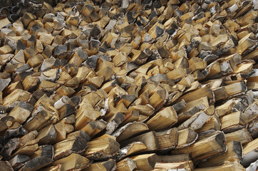 Birch firewood stacked in a woodpile to heat house