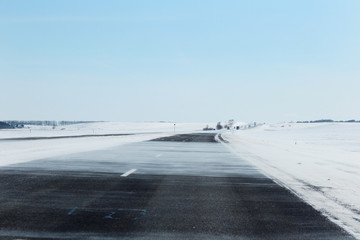 Winter road and snowdrifts on the motorway