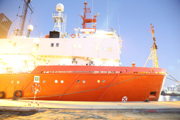 big red ship on the seashore side