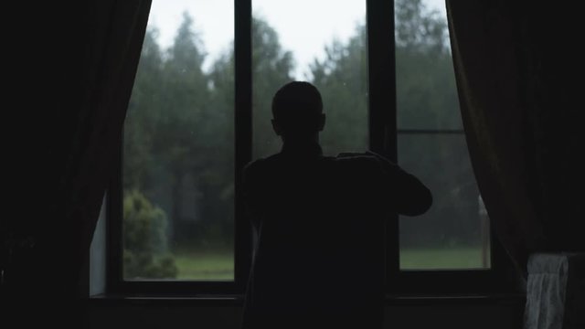 Man Dresses Near Window