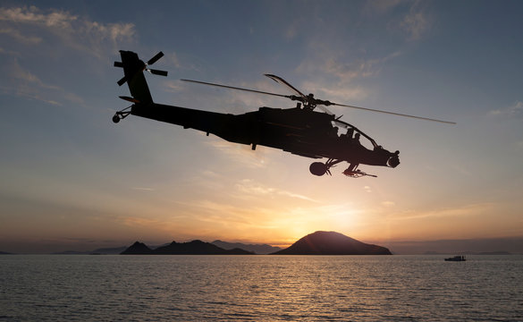 attack helicopter on the sun set