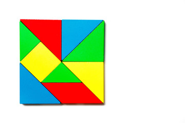 Colorful wood toy puzzle in geometric square shape on white background