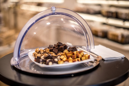 Pieces of turron for taste in serving dish plate in sweet-shop