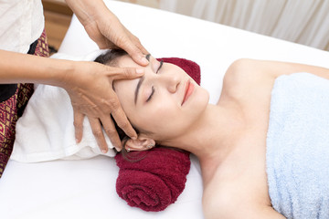 Fototapeta na wymiar Beauty healthy lifestyle and relaxation concept, Close up of beautiful young woman lying with closed eyes and preparation face or head massage in spa or wellness.
