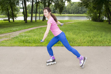 Pretty young and slim woman on roller skates relaxing and having fun on beautiful alley next to the river, active lifestyle concept.