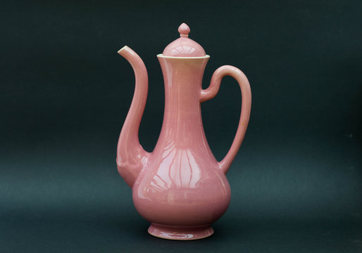 Pink porcelain pot on black background