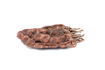 Close up view of brown tamarind ripe isolated on white background.