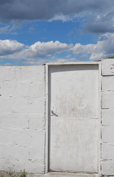 white door to the clouds and sky