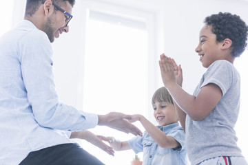 Obraz premium Happy children play clapping hands