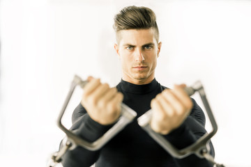 Obraz na płótnie Canvas Young man training in a gym
