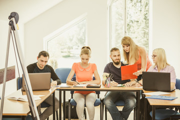 Students and teacher tutor in classroom