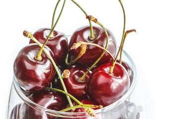Close up fresh cherry in glass isolated on white background. Copy space. Creative design menu concept. Summer background.