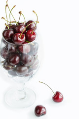 Fresh cherry in glass isolated on white background. Close up. Copy space. Creative design menu concept. Summer background.