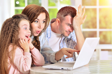 Happy family with laptop 