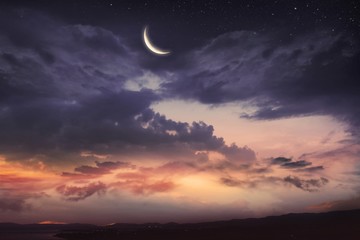  Prayer time .  Dramatic nature background .    Red sunset and moon .  Ramadan background . Arab...