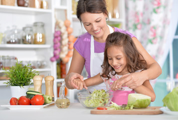 Mother and daughter preparing dinner