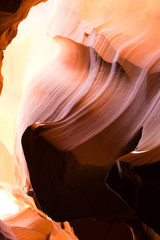 vertical view of a slot canyon in Arizona in beautiful hues of red, orange and yellow