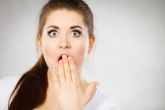 Shocked amazed woman covering mouth with hands