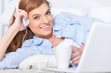 young woman lying in front of laptop