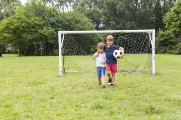 Two brothers having fun playing with ball