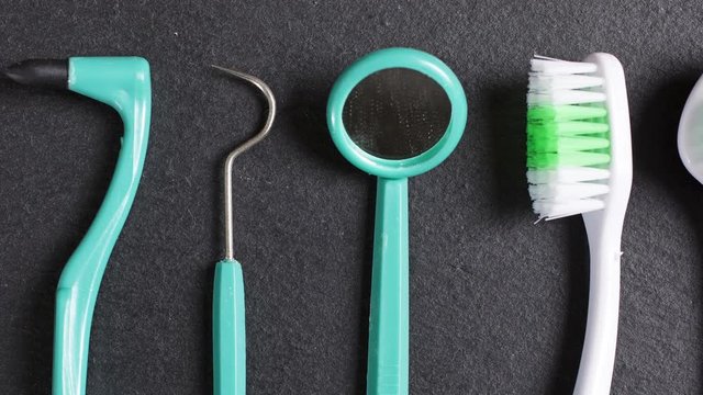 Slowly panning over dentist tools on a slate surface