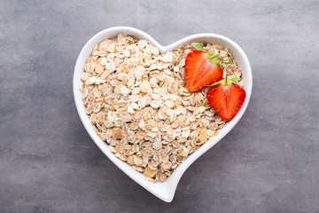 Dry rolled oatmeal in bowl.