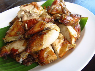 Close-up grilled chicken with sauce in white plate