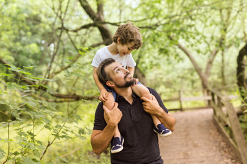 Fototapeta premium Father and son in forest on a meadow