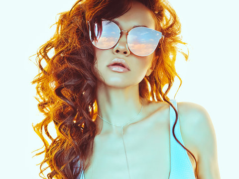 Beautiful  woman in pink-blue sunglasses