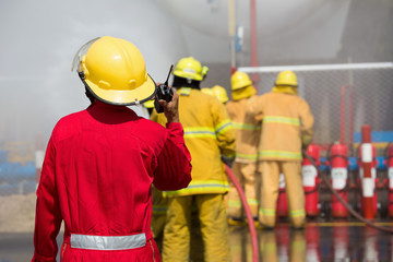 Fototapeta premium Firefighters spray water in fire extinguishers caused by explosive gas