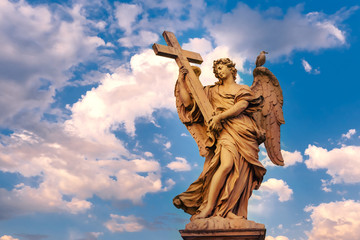 Fototapeta premium Marmurowy posąg anioła z krzyżem o zachodzie słońca, jeden z dziesięciu aniołów na moście Świętego Anioła, symbole męki Chrystusa, Rzym, Włochy