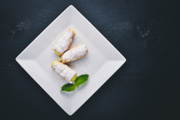 Pastry with Cream. On a wooden background. Top view. Free space for your text.