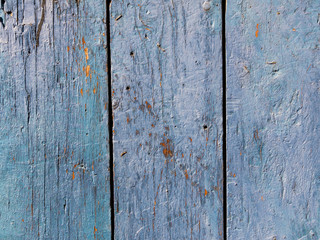 Old wooden surface with the remains of the blue paint