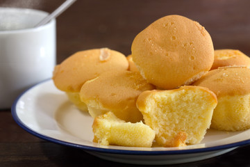 Butter cupcake and black coffee on old brown wooden / Selective focus image.