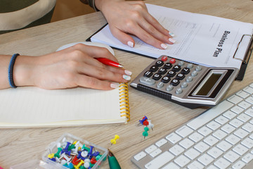 Close up view of bookkeeper or financial inspector hands making report, calculating or checking...