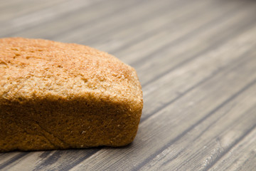 Whole Wheat Loaf of Bread on a Wooden Table