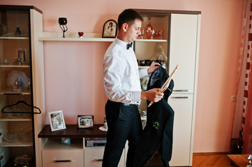 Portrait of an attractive groom dressing up for his wedding.