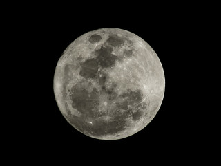 Close up of the full moon texture in the night time. Full moon isolated on black background.