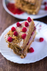 Homemade cake baking on a platter on a wooden background.