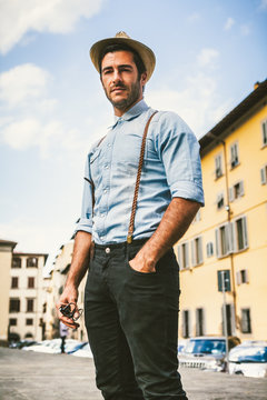 Handsome Man with a Vintage Denim Shirt Exploring an Old Italian Town