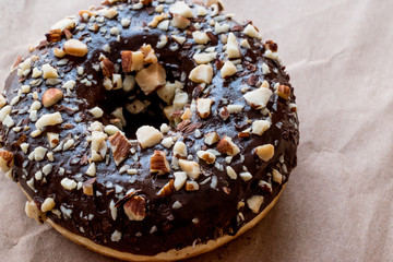 Chocolate Donut with Diced Hazelnut pieces.