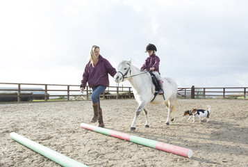 Mother with her daughters and their pony.