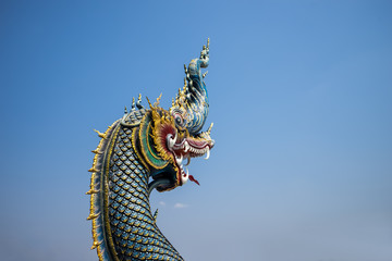 Fototapeta premium The naga statue on blue sky background in thailand.