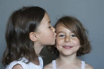 Love between sisters. A gentle kiss on the cheek