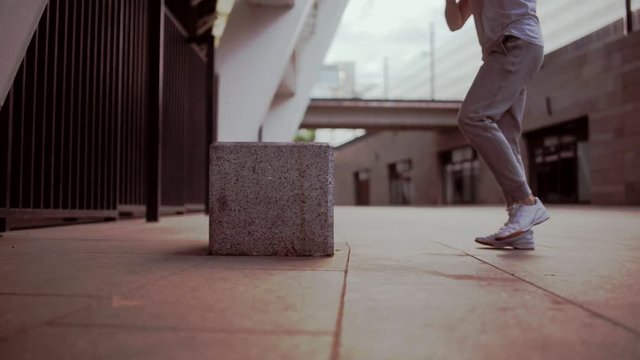 Dolly shot of a man doing step exercises