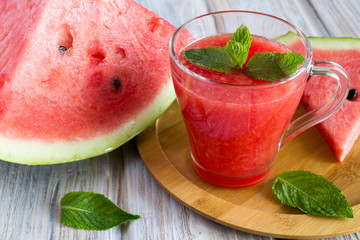 Smoothie from watermelon on the cutting board on the wooden background 