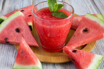 Smoothie from watermelon on the round brown cutting board  - Powered by Adobe